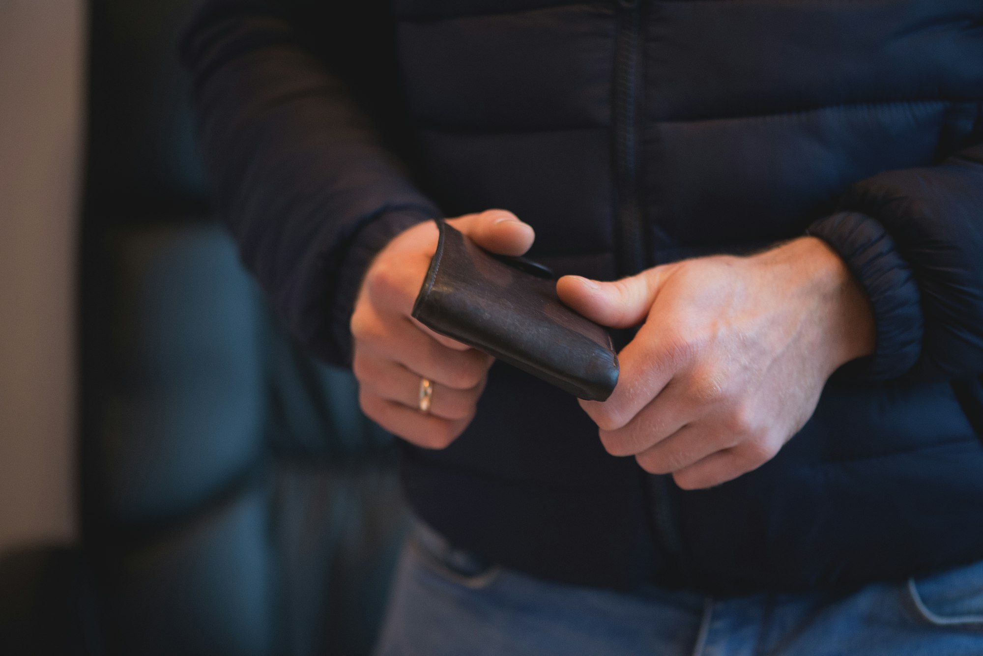 Man holding wallet, close-up of hand